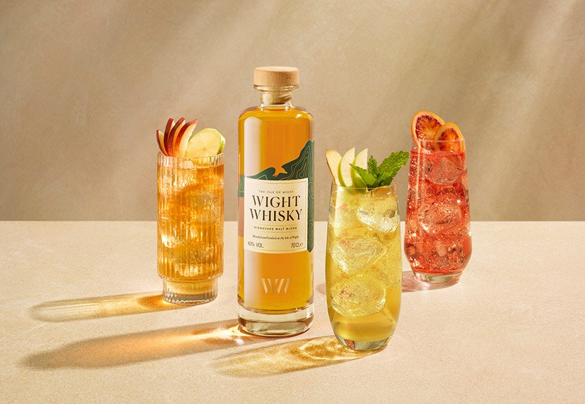 A bottle of Wight whisky and 3 cocktails.