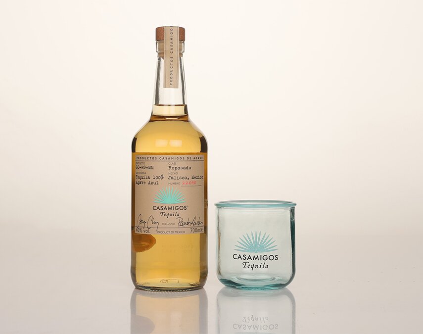 A bottle of Casamigos Reposado Tequila with branded glass