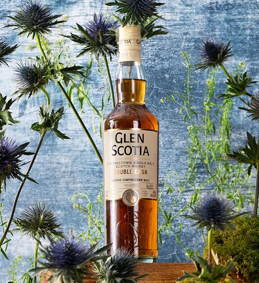 A bottle of Glen Scotia Double Cask surrounded by thistles.