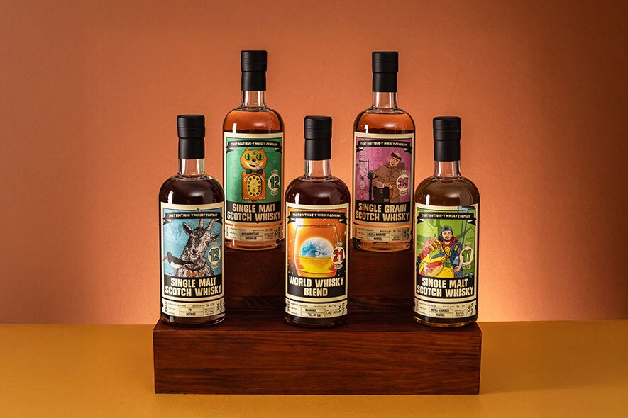 Five bottle of That Boutique-y whisky against an orange background.