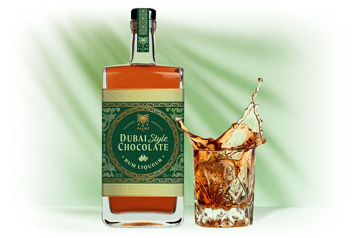 A bottle of Dubai Style Chocolate Rum Liqueur, next to a filled glass