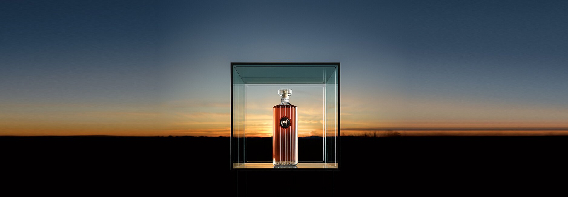 A  bottle of SirDavis Whisky in a glass box against a sunset background.