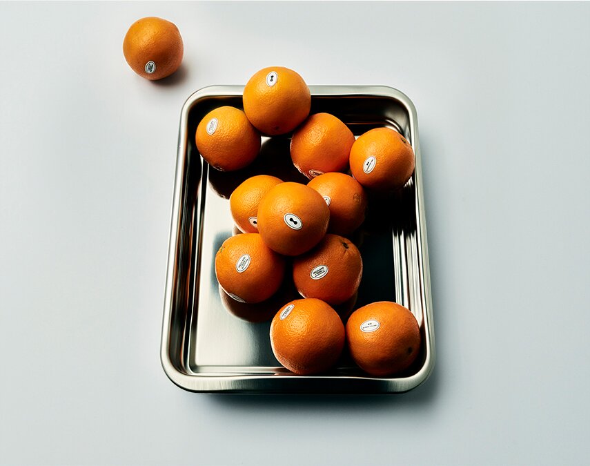A metal tray filled with oranges