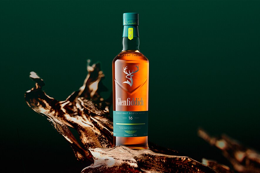 A bottle of Glenfiddich 16 year old x Aston Martin against a green background.