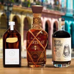 Three bottles of Rum on a city street background.