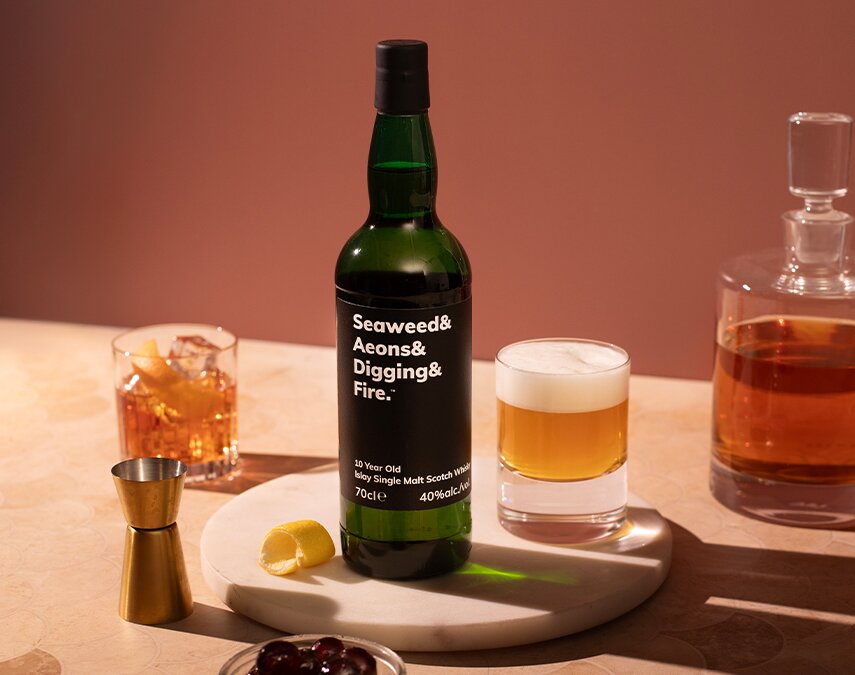 A bottle of Seaweed & Aeons & Digging & Fire 10 Year Old, which a Whiskey Sour.