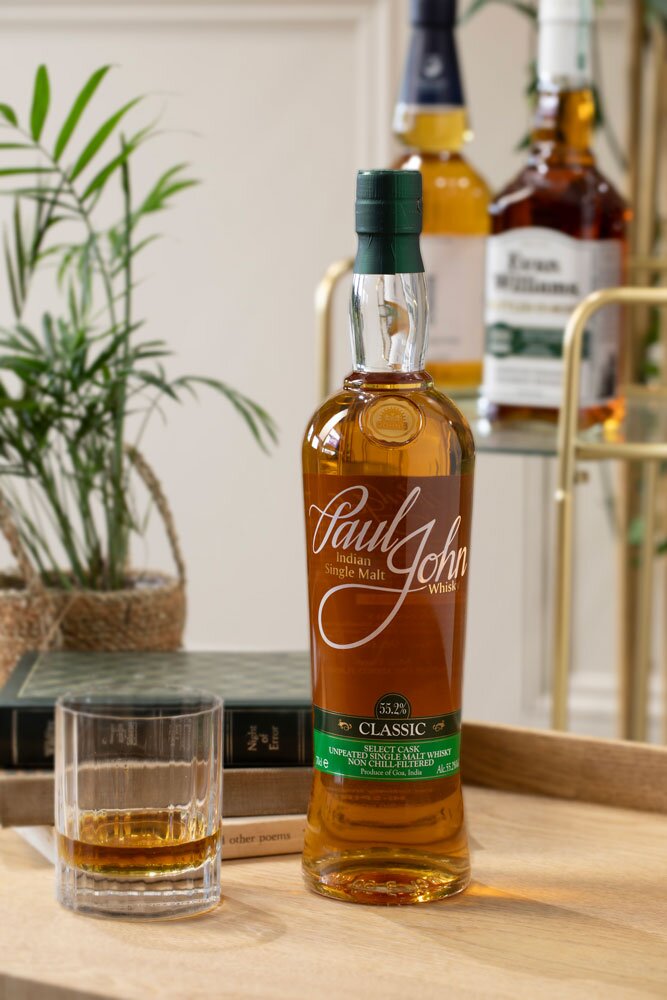 Paul John Classic Select Cask whisky bottle with glass