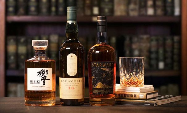 Bottles of Hibiki, Lagavulin, Starward and a glass of whisky.