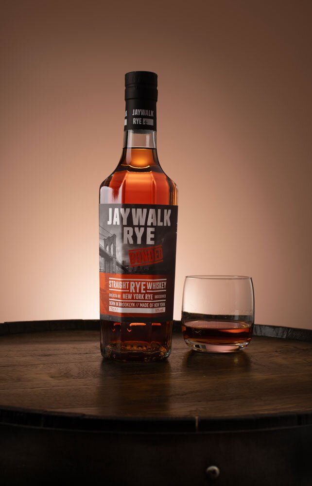 Jaywalk Bonded Rye whiskey bottle with tumbler glass