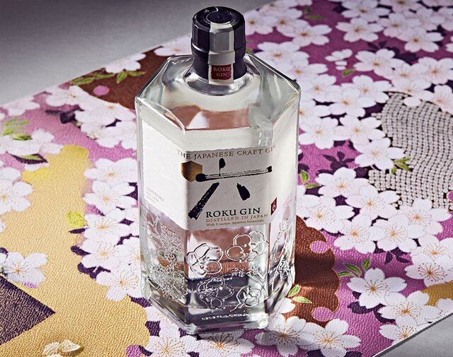 A bottle of Roku  against a cherry blossom background.