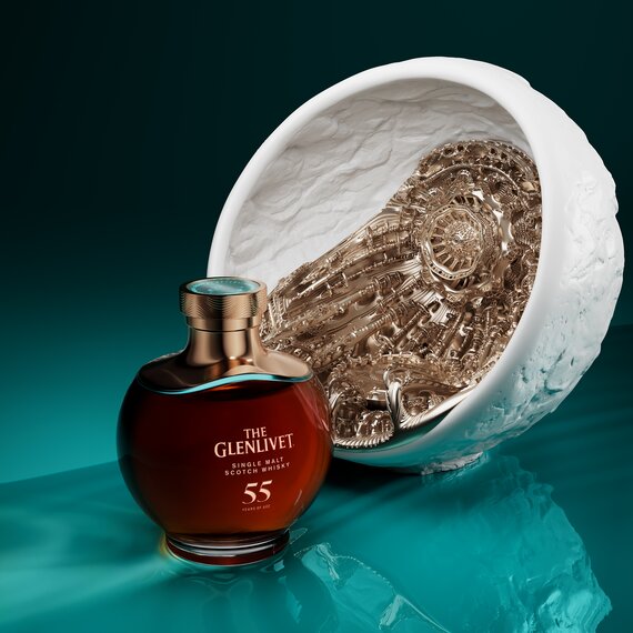 A bottle of the Glenlivet 55 Year Old next to its presentation stand.
