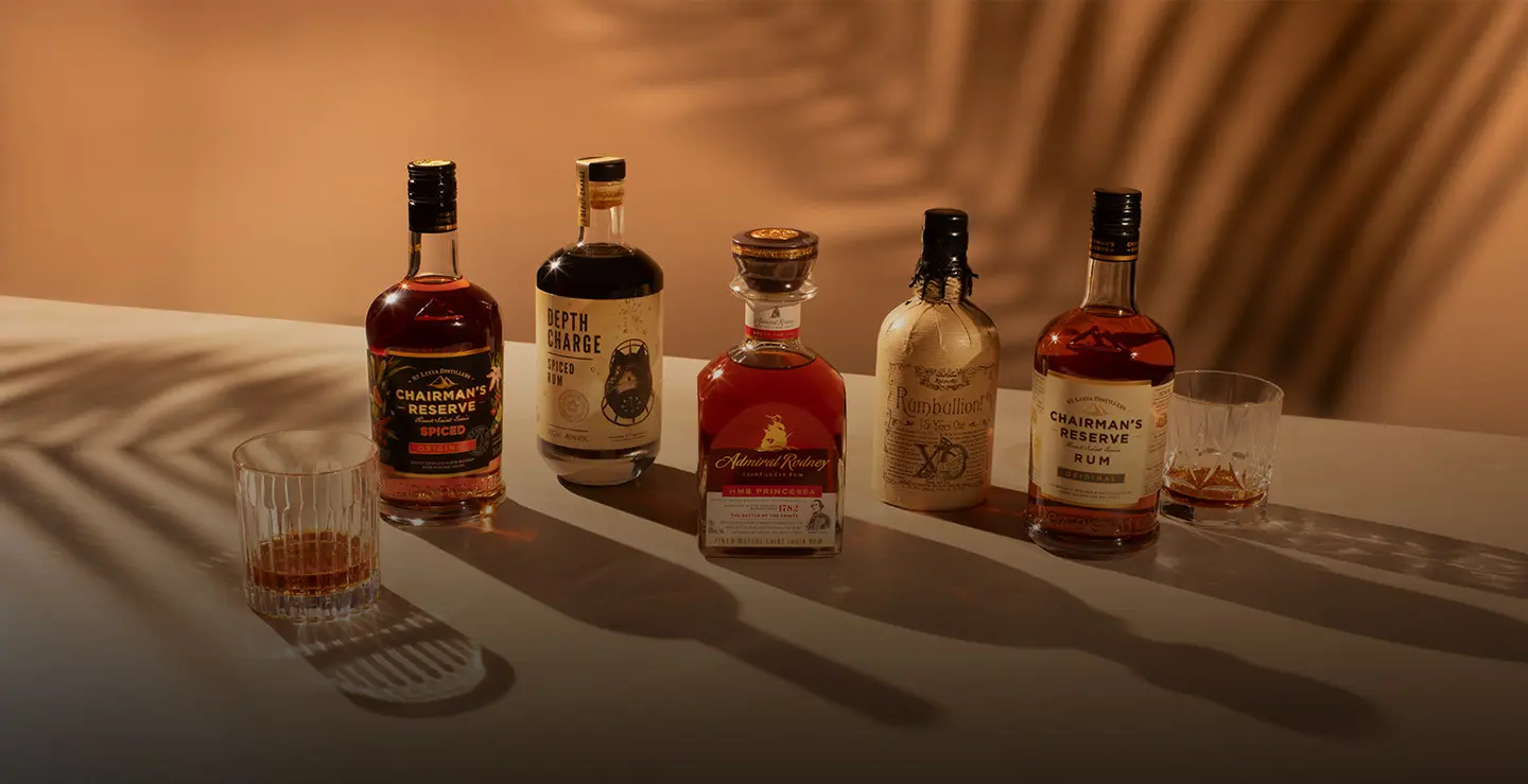 Fie bottles of rum on a beige background.