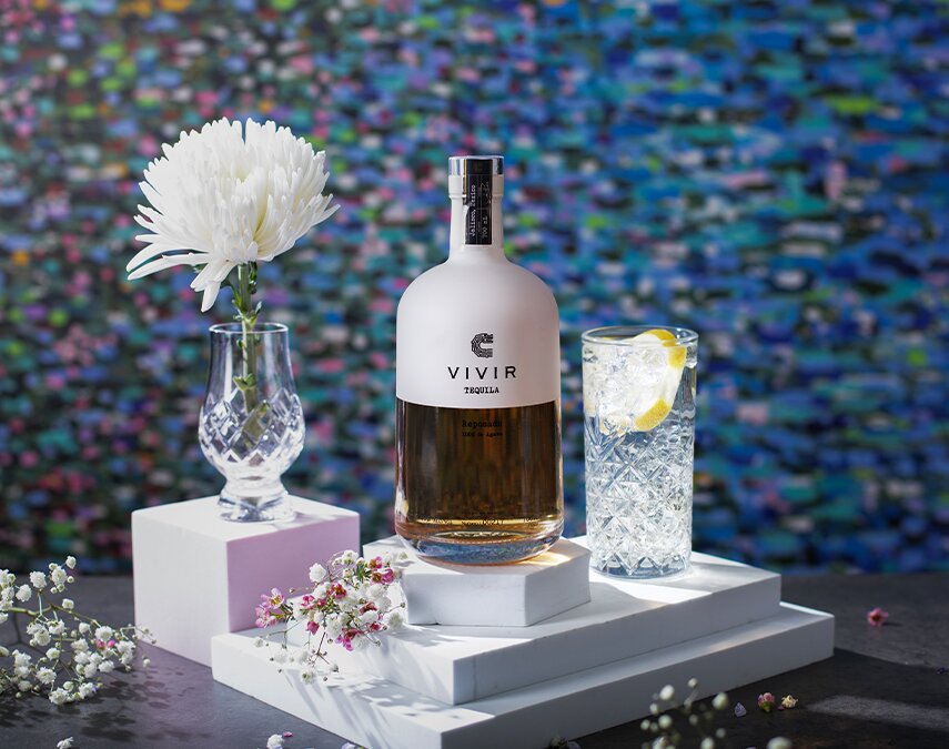 A bottle of VIVIR Tequila Reposado.