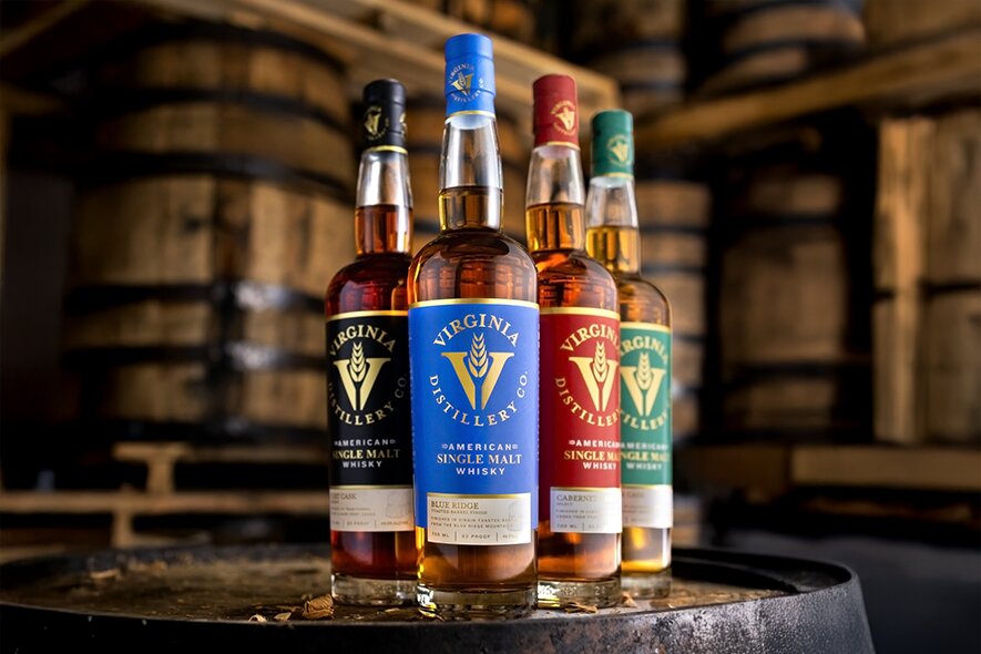 Four bottles of Virginia Distillery whiskey on a barrel. 