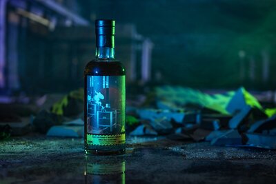 A bottle of Arran the Bothy on top of a map of Scotland. 