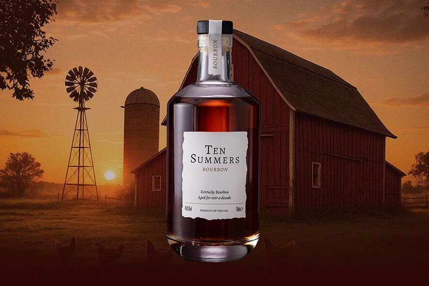 A bottle of 10 Summers whiskey against a farm background.