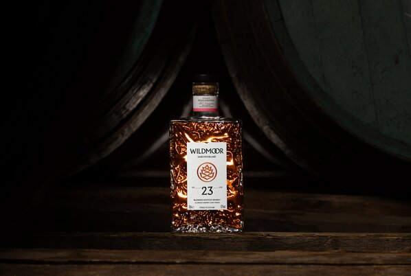 A bottle of Wildmoor 23 on a barrel 