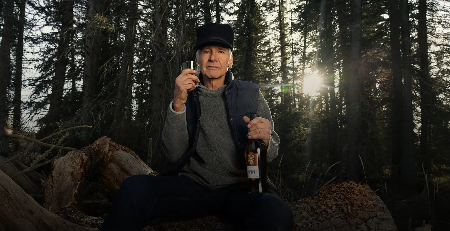 Harrison Ford holding a bottle of Glenmorangie X Harrison Ford whisky