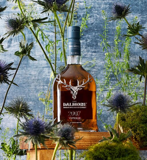 A bottle of Dalmore Vintage 2007 surrounded by thistles. 
