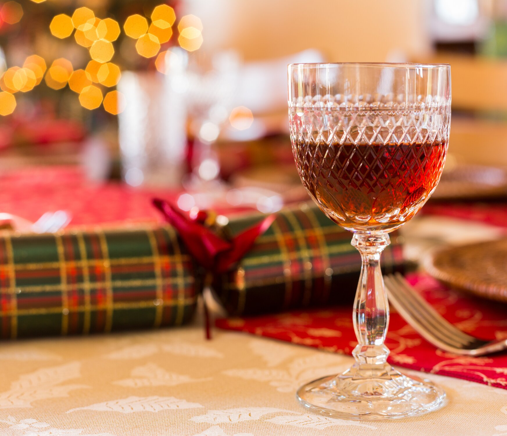 A glass of sherry wine on a table laid out for Christmas dinner