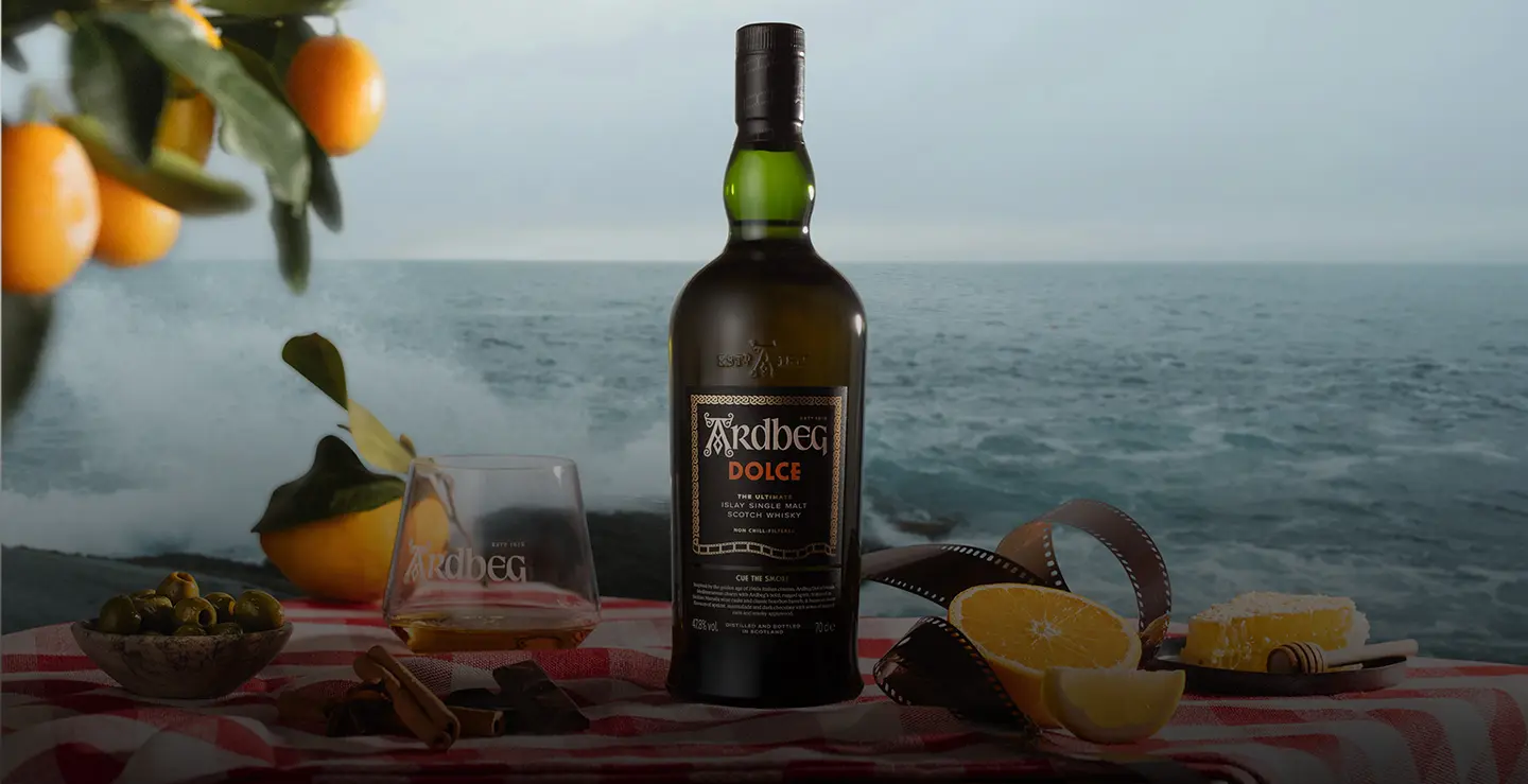 A bottle of Ardbeg Dolce with a branded Ardbeg glass.