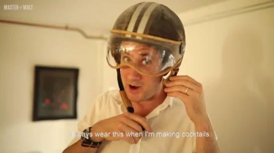 Henry Jeffreys wearing a bike helmet to make cocktails