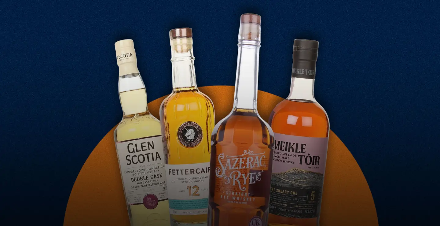 Four bottles of whisky on a blue background.