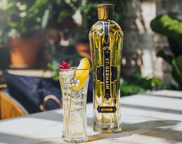A bottle of St-Germain Elderflower Liqueur with a St-Germain Spritz.