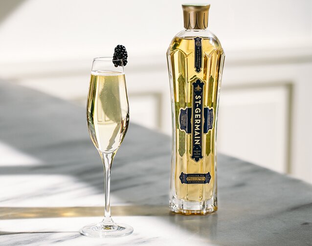 A bottle of St-Germain Elderflower Liqueur with a St-Germain Royale cocktail.