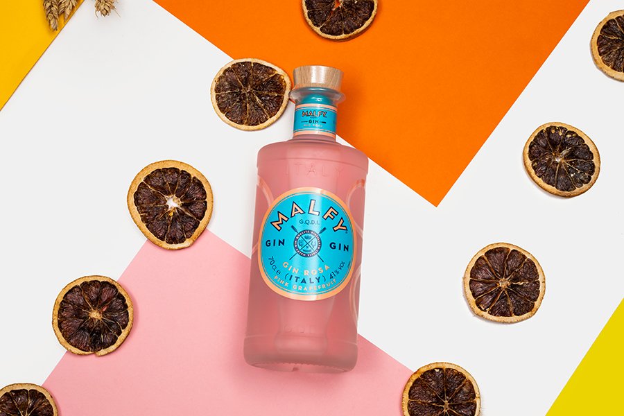 A bottle of Malfy Gin surrounded by dehydrated citrus wheels