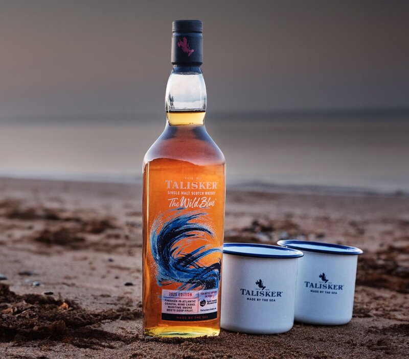 A bottle of Talisker The Wild Blue with two branded mugs