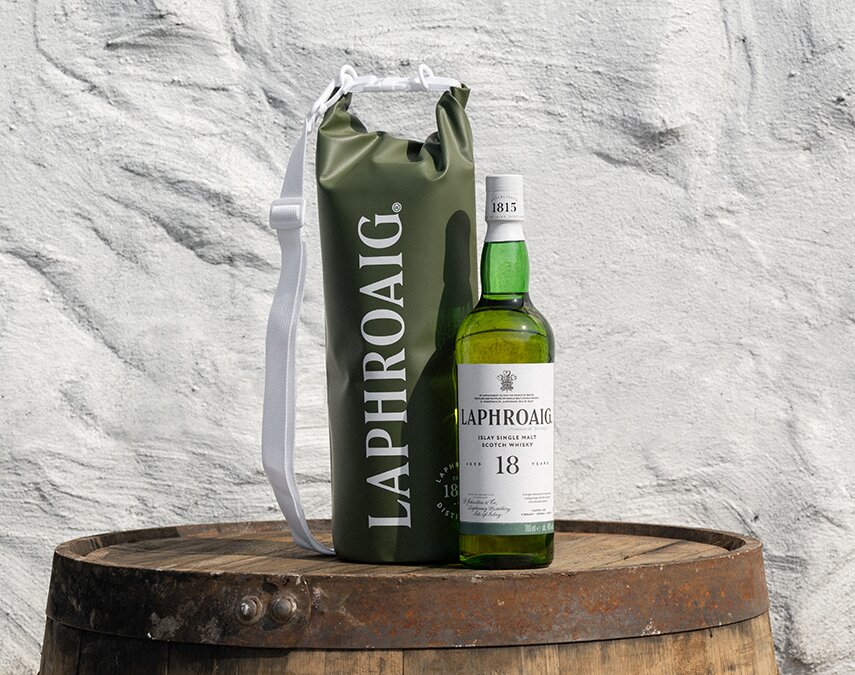 A bottle of Laphroaig 18 year old and Laphroaig branded dry bag