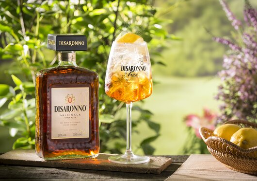 Bottle of Disaronno next to a Disaronno Fizz serve.