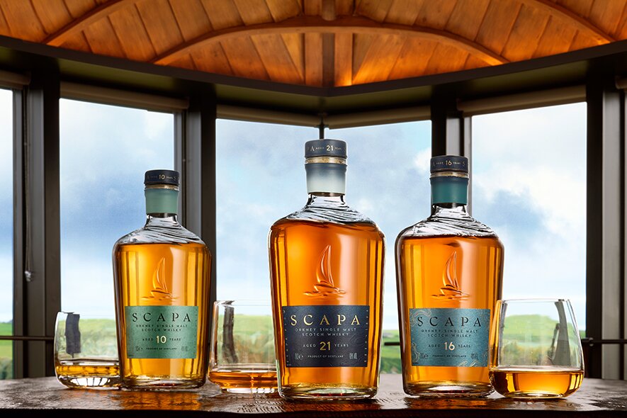 Three bottles of Scapa in a room with big windows.