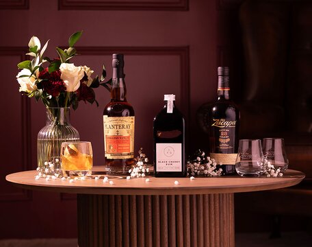 Three bottles of rum with two glasses