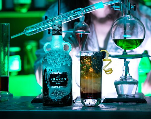 The Graveyard Smash cocktail next to a bottle of The Kraken® Black Spiced The Lighthouse.