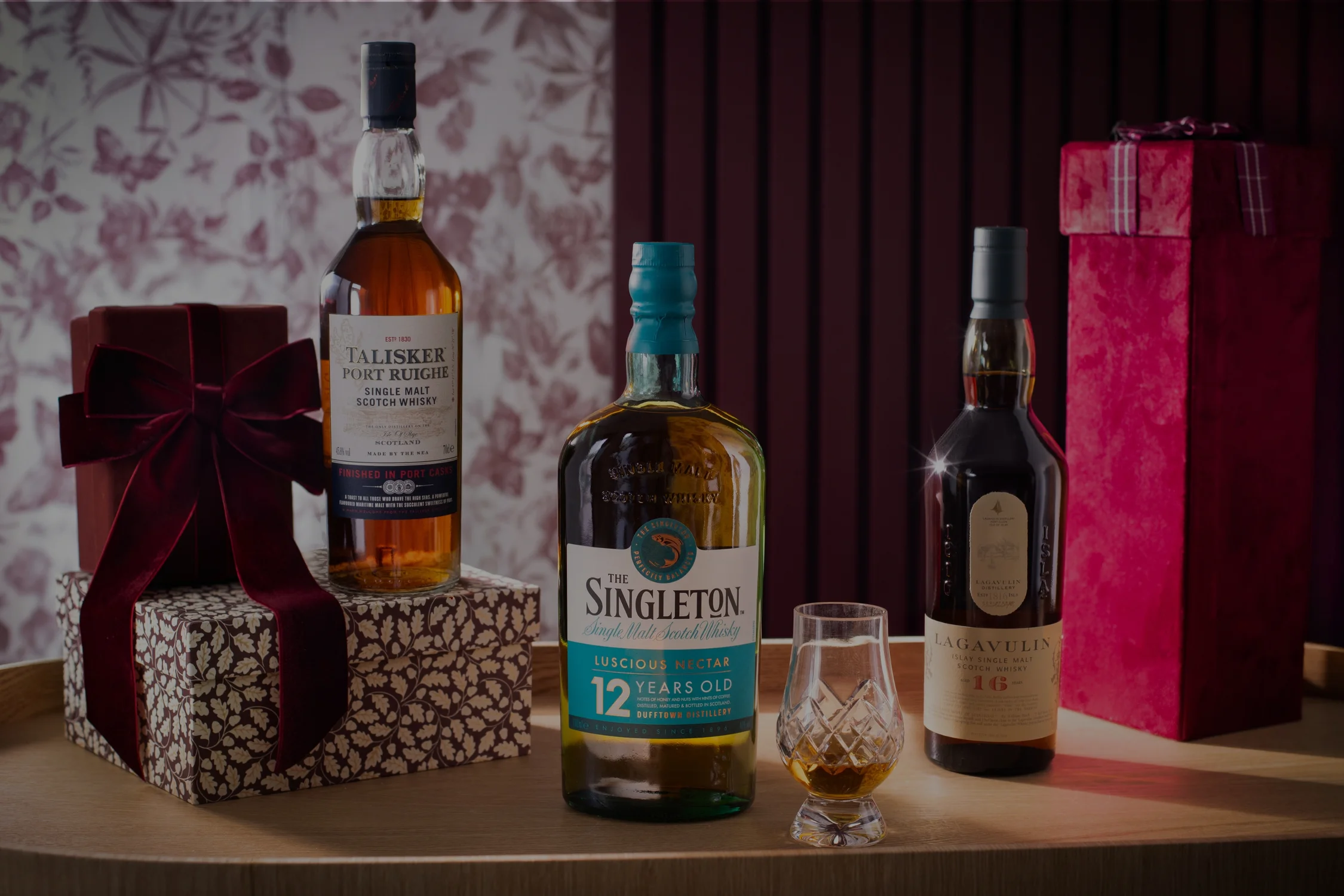 Three bottles of whisky with a valentines day background