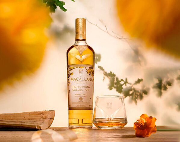A bottle of The Macallan Harmony Collection Vibrant Oak with a dram