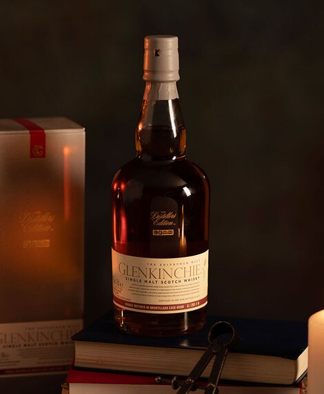 A bottle of Glenkinchie Distillers Edition 2022 Collection whisky against a dark background and it's presentation box. 