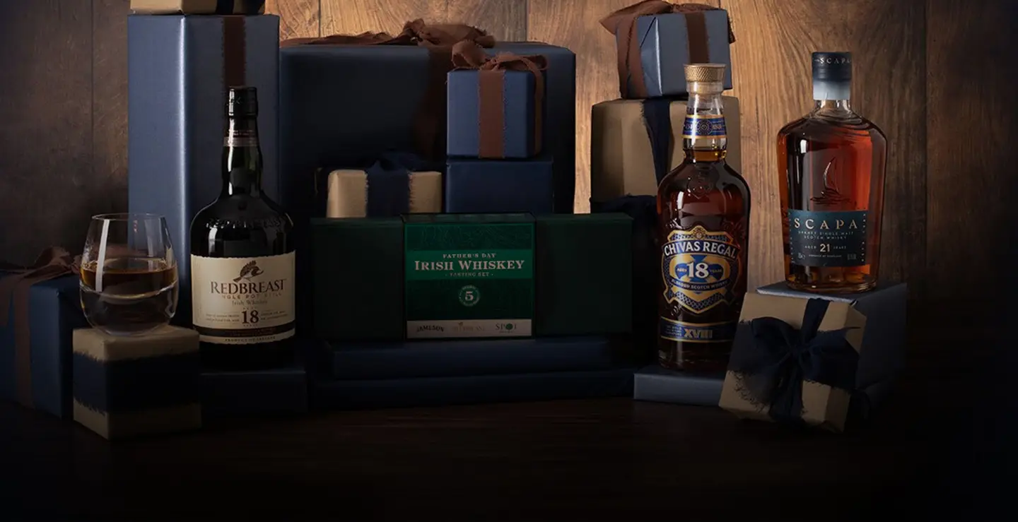 A bottle of Redbreast 18, Pernod Irish tasting set, Chivas 18 and Scapa 21 surrounded by blue and brown presents.