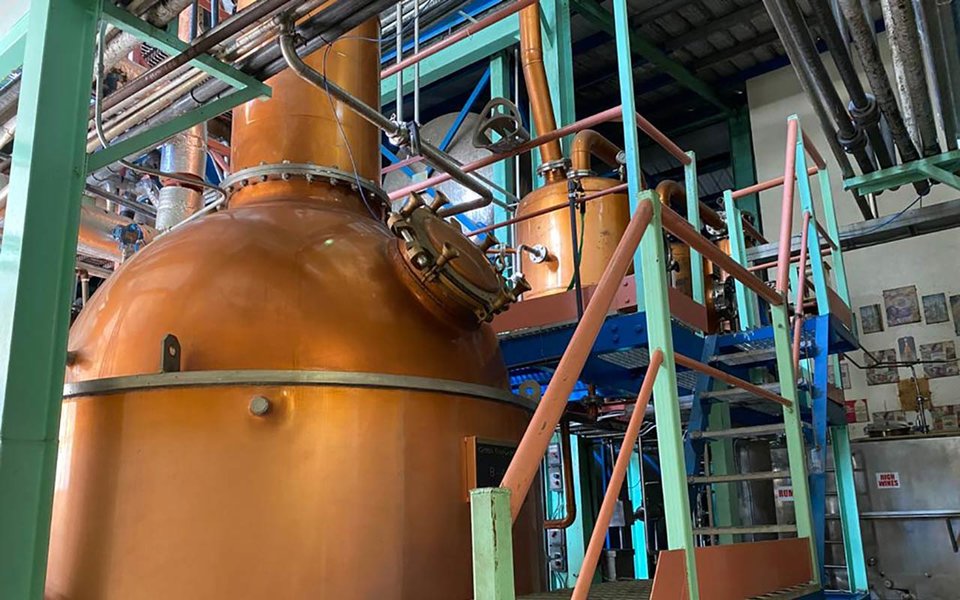 A pot still at Foursquare distillery in Barbados, with retorts on a raised platform next to the main still.