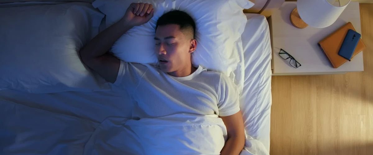 Man sleeping on a full size bed 