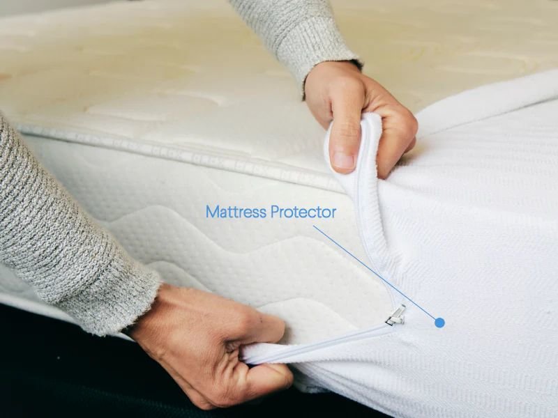 Man putting mattress protector on mattress