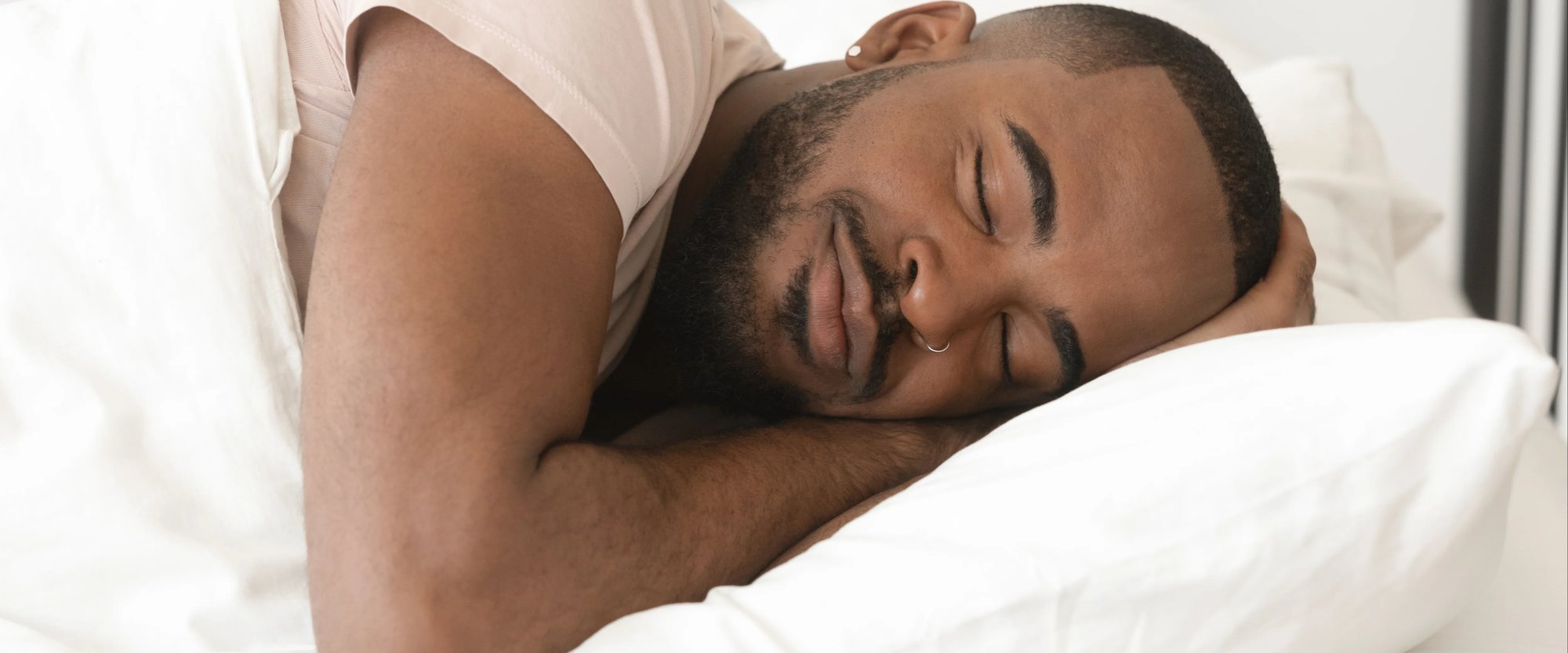 Man sleeping on his side on a pillow