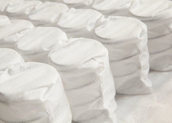 Mattress coils wrapped in fabric sleeves