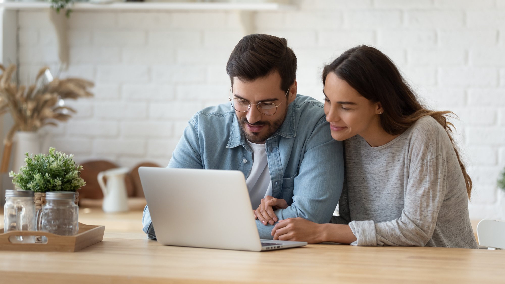 Man and woman looking at computer together and online shopping