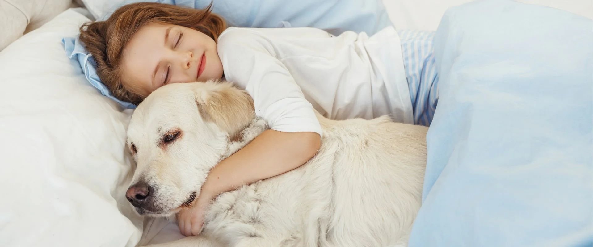 Young girl sleeping and hugging dog