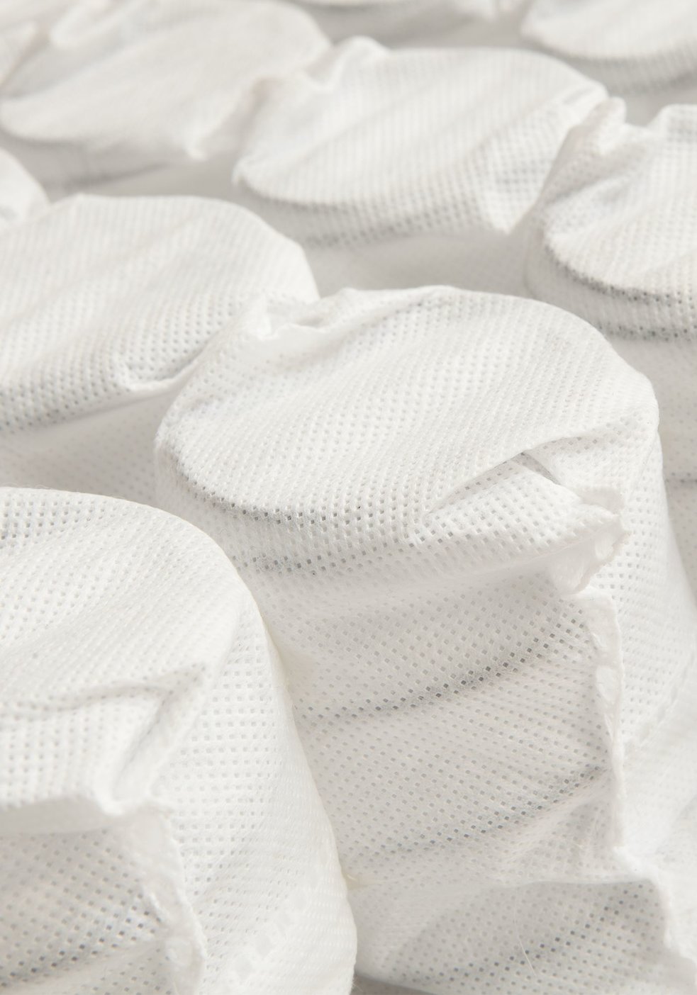 Individually-wrapped mattress coils encased in fabric