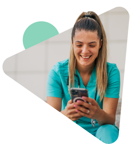 Woman in scrubs looking at phone