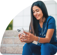 Nurse sitting looking at phone